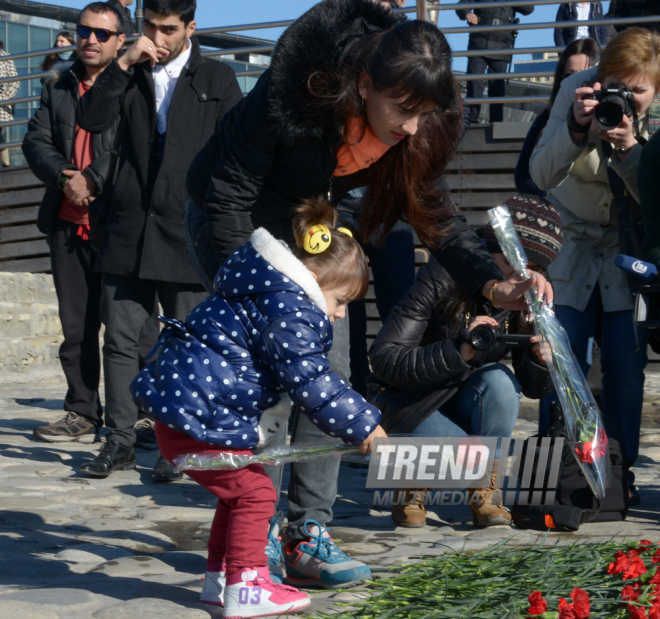 Baku residents bringing flowers to Seaside Boulevard to honor missing oil workers.  Azerbaijan, Dec.07, 2015